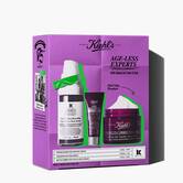Kiehl's "Age-Less Experts" anti-aging skincare set, featuring a retinol serum, eye cream, and multi-corrective cream.