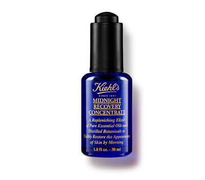 Steklenička seruma Kiehl's Midnight Recovery Concentrate, modra, z črnim pokrovčkom, namenjena obnovi kože.