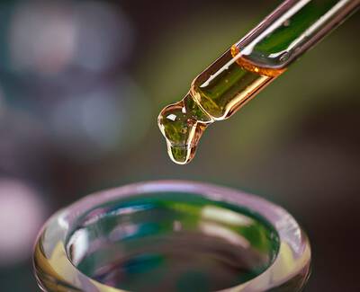 A close-up view of various roasted coffee beans scattered together, showcasing different shapes and shades of brown.